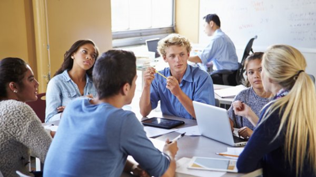 Young people engaging in discussion , around personal development.