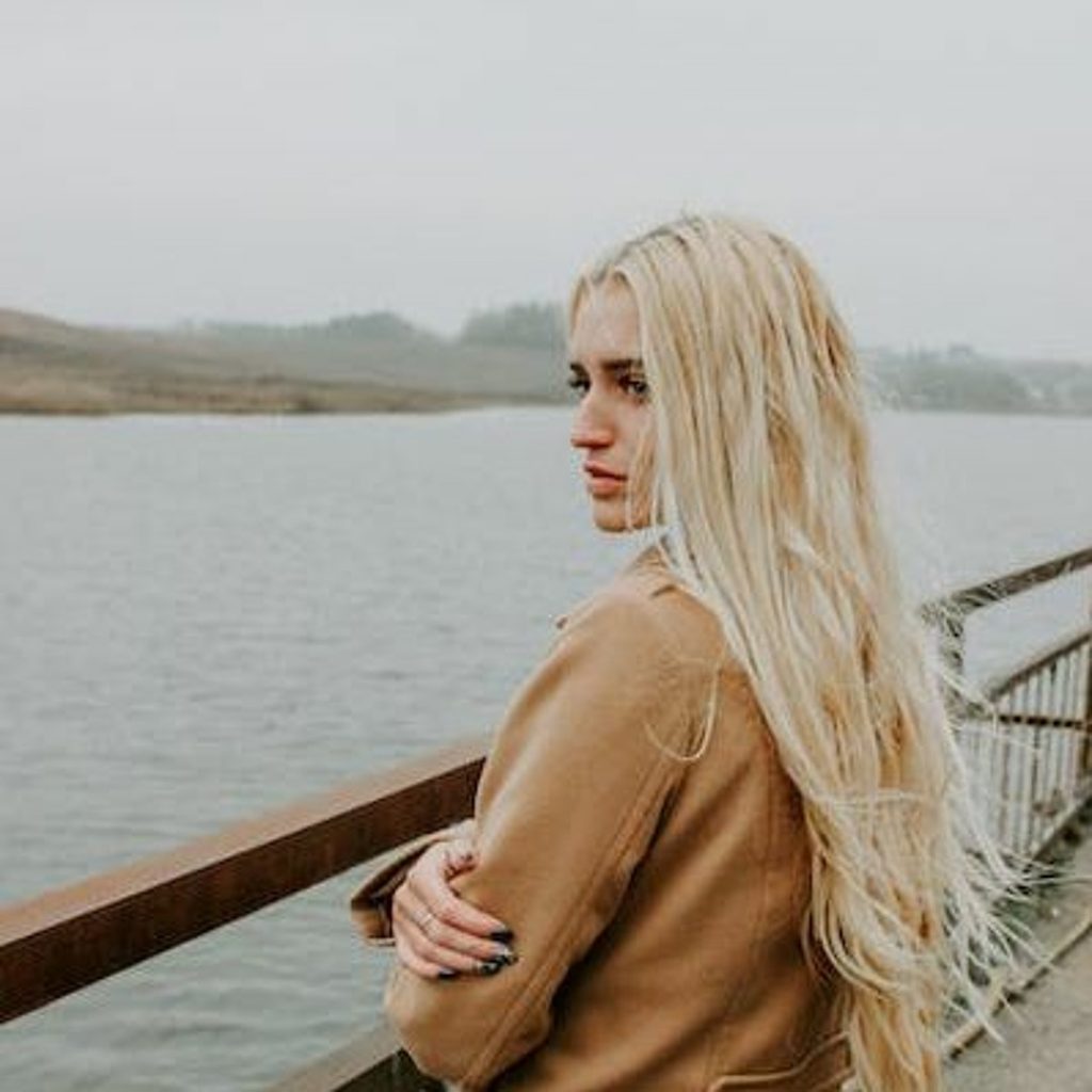 A blonde woman reflecting her personal development